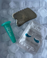 Face Pilates skincare set arranged on ice cubes, including a metallic forehead/eye massager tool, a teal applicator wand, and a packet of water-based eye mask patches.