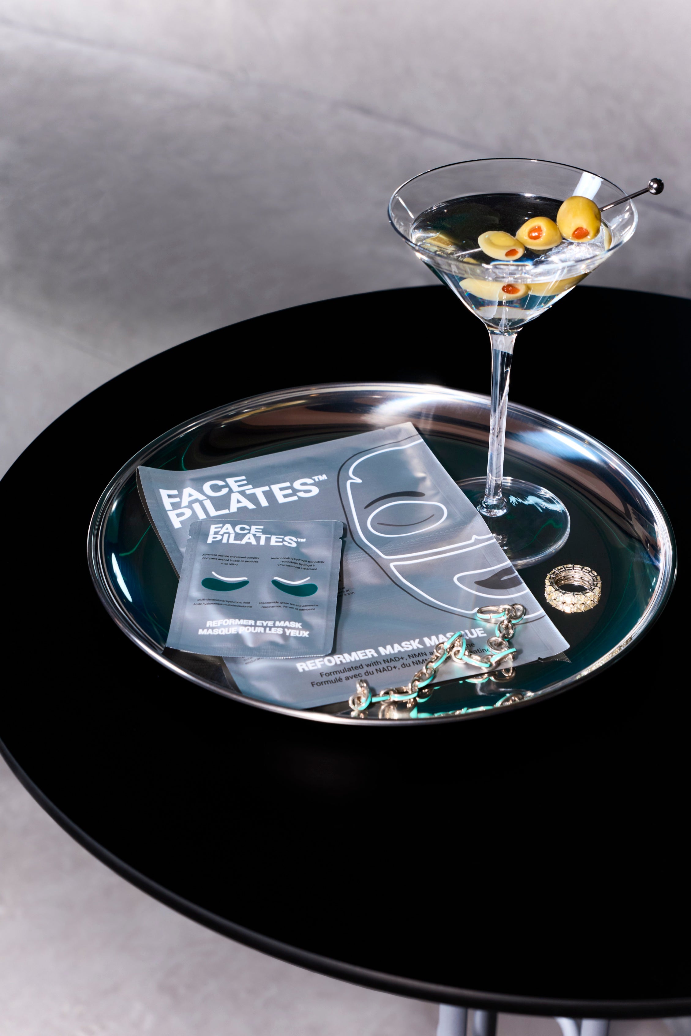 Face Pilates masks with martini — lifestyle flat lay